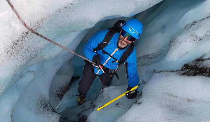 A man looks up through the valley of an outlet glacier at Vatnajokull glacier.