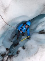 A man looks up through the valley of an outlet glacier at Vatnajokull glacier.