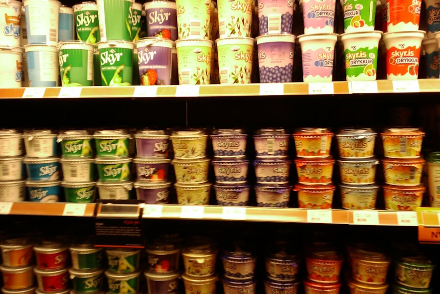 A row of skyr tubs in a grocery store.