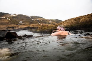 Travelers can enjoy the hot springs of Reykjadalur, while surrounded by nature.
