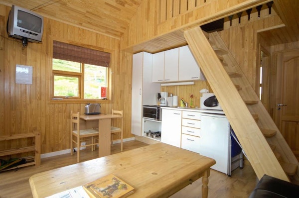 Solbrekka Holiday Homes' kitchen and dining area, with a toaster, a coffee maker, and an oven.
