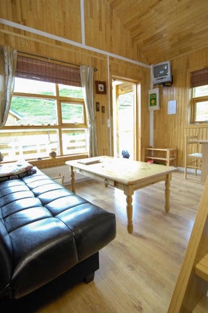 Solbrekka Holiday Homes shared living area is complete with a sofa and a table.
