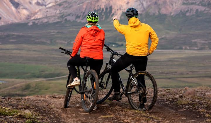 Mountain bikers stop to appreciate the rugged mountain scenery of the Eastfjords.