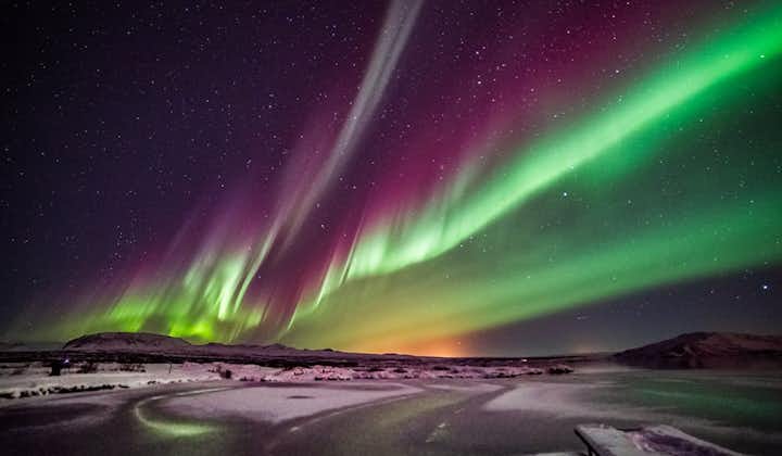 The beautiful northern lights shining in the sky above the Reykjadalur valley.
