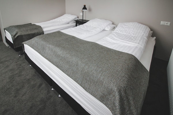 A triple room in Bella Hotel, with one single bed and one double bed.
