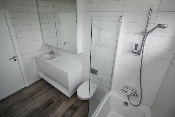 The bathroom of the penthouse apartment in Bella Hotel with a walk-in shower.