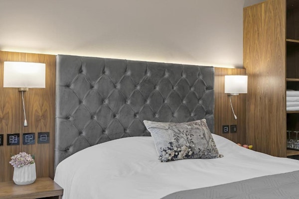 Close-up of a luxurious headboard and bed at the Alva Hotel.