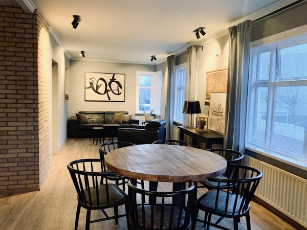 A dining table with chairs in the living area of this accommodation apartment.