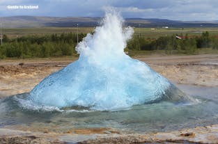 The Strokkur geyser erupts every 5-10 minutes in the Geysir geothermal area, one of three Golden Circle attractions.