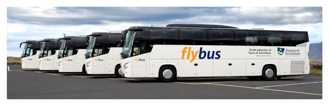 A couple of flybus buses parked next to each other.