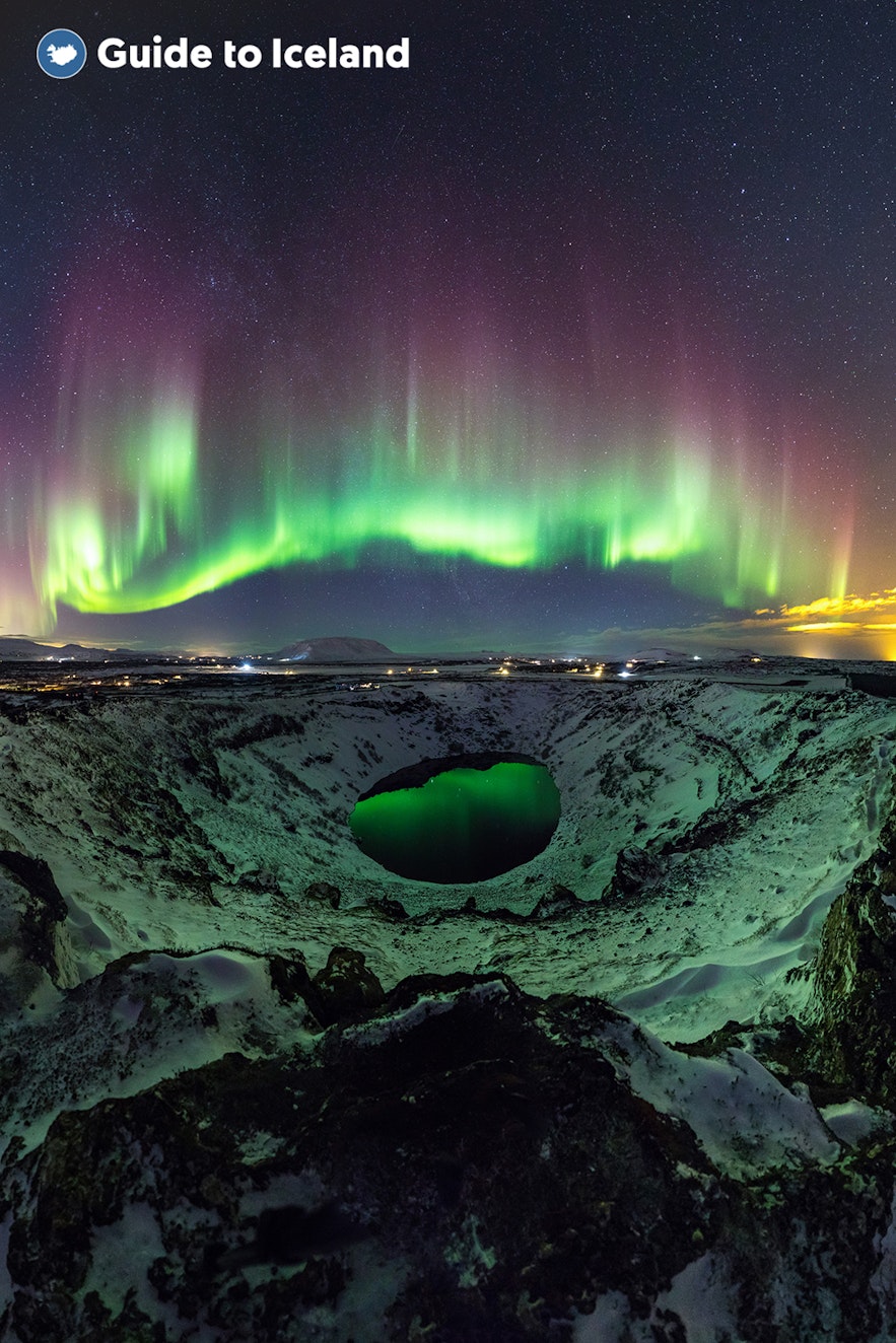 The Kerid crater under the northern lights during winter.