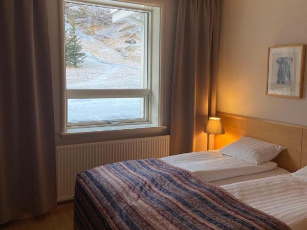 A double room at Dala Hotel with a scenic countryside view out the window.