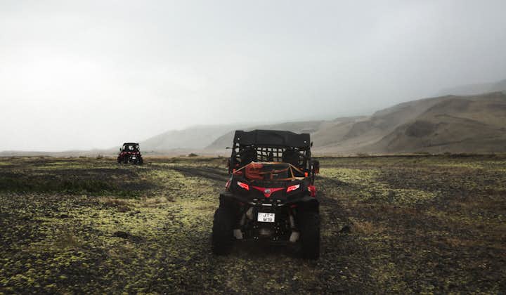 Two buggies drive through the mist in the Thorsmork valley.