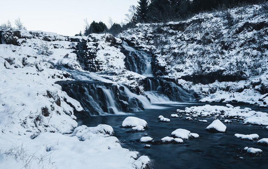 Kermoafoss waterfall during winter in the valley of Ellidarardalur near the city of Reykjavik