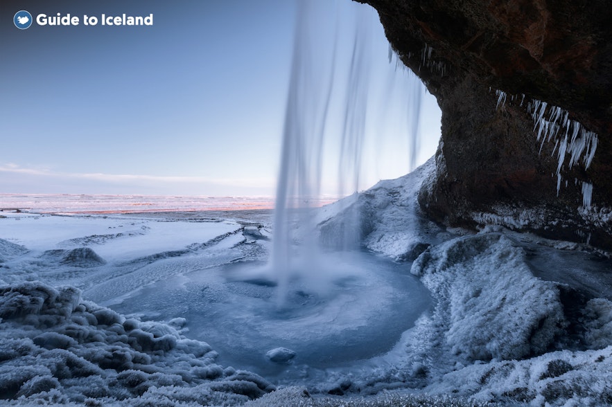Seljalandsfoss waterfall in South Iceland, with frozen icicles and snow during winter