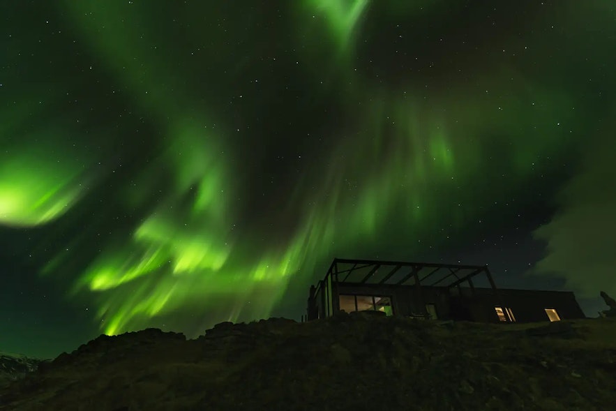 Watch the aurora borealis at the Hvammsvik Retreat in winter.