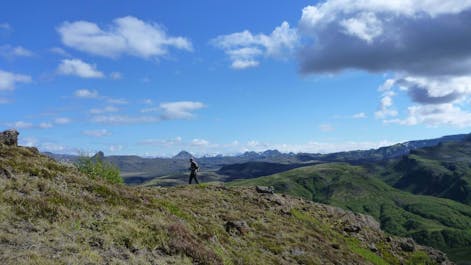 A hiker walks along a ridge in the Laugavegur hiking area of Iceland.