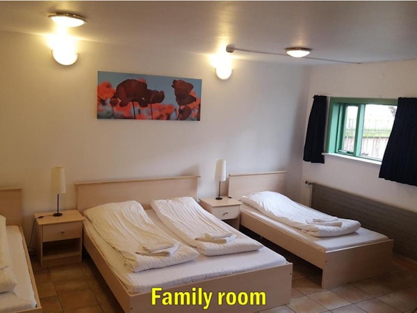 The family room at Travel Inn Guesthouse has a double bed and two single beds.