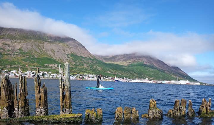 Stand-up paddle boarding is a fun and relaxing way to explore the calm fjord waters of North Iceland.