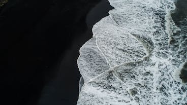 The Atlantic Ocean coastline on the Reynisfjara black-sand beach in South Iceland.