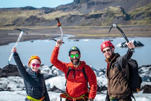 Two travelers enjoy an exciting glacier hike on the Solheimajokull glacier on this small-group South Coast tour.