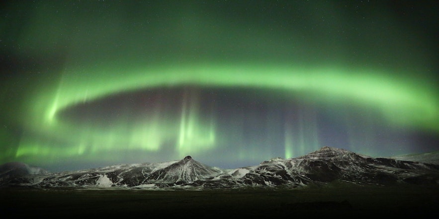 Zorza polarna nad górami na Islandii.