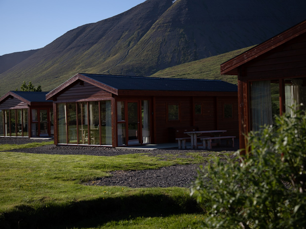 The Dalasetur cabins on the Trollaskagi Peninsula have a gorgeous mountain backdrop and grass stretched in front.