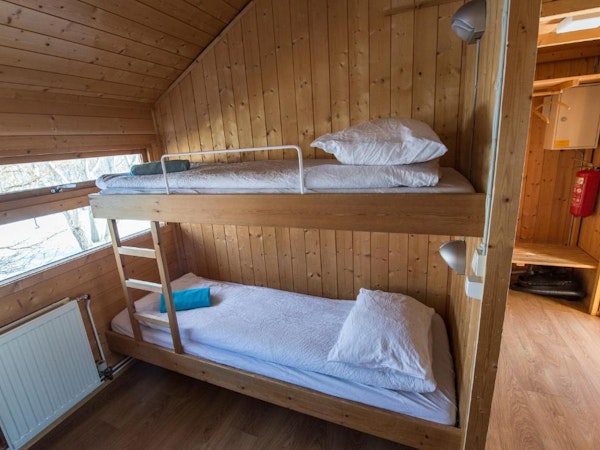 Two wooden bunk beds at Gladheimar cottages.