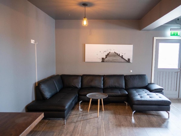 The large, comfortable sofa in the communal area at North Star Guesthouse Snaefellsnes in central Olafsvik.