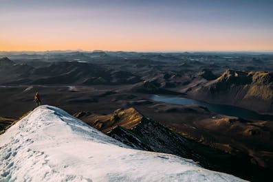 The sun sets over the mountain ranges of the Highlands in Iceland.
