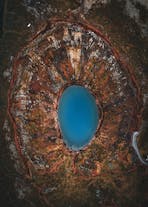 The stunning turquoise-blue waters of the Kerid crater lake, as seen from above.