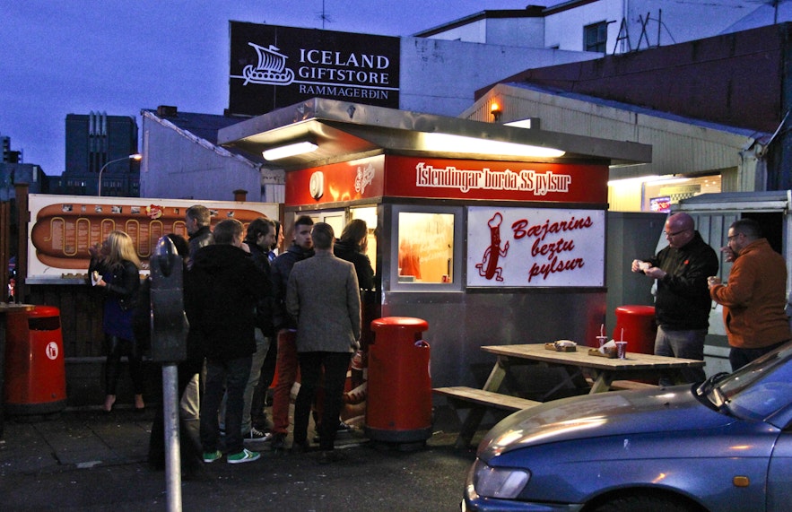 Travelers lining up to order delicious hot dogs in Reykjavik.