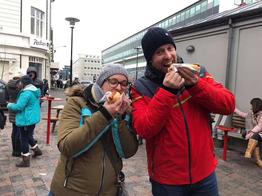 Tour joiners in Iceland sampling Icelandic hot dogs.