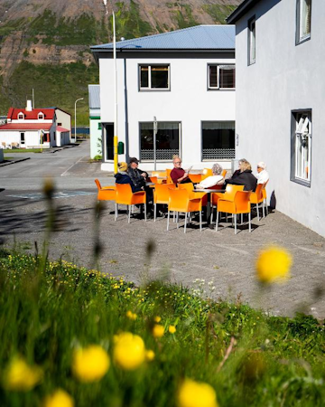 When the weather is mild, guests can relax on the outdoor furniture at Fisherman Guesthouse Sudureyri in the Westfjords.