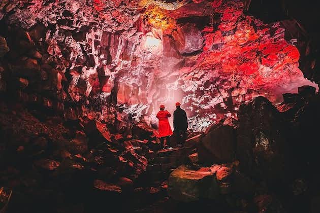 Two people enjoy the view of the interior of a lava tunnel on the Reykjanes Peninsula in Southwest Iceland.