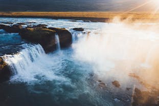 Capture the ethereal beauty of Godafoss, the 'Waterfall of the gods,' as it cascades majestically against Iceland's rugged landscape.