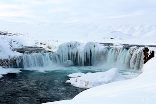 Godafoss waterfall transforms into an icy wonderland during winter.