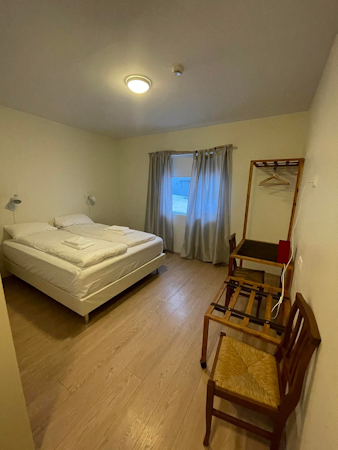 One of the double bedrooms at Hotel Studlagil with bed, desk, and chair.