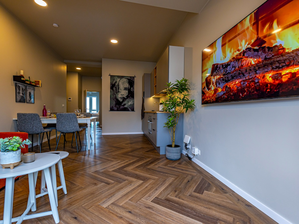 The stylish interiors at SJF Apartments feature parquet floors and artwork.