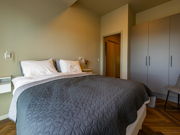 A large double bed in one of the bedrooms at SJF Apartments.