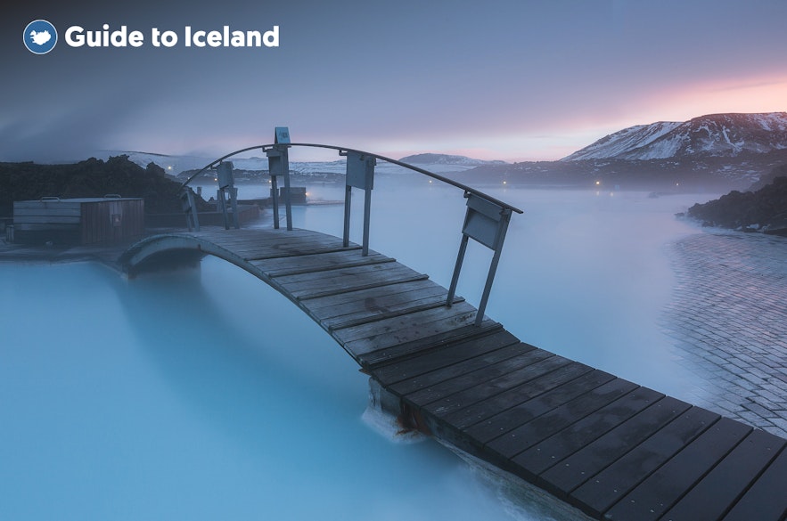 A bridge crosses the steamy waters of the Blue Lagoon.