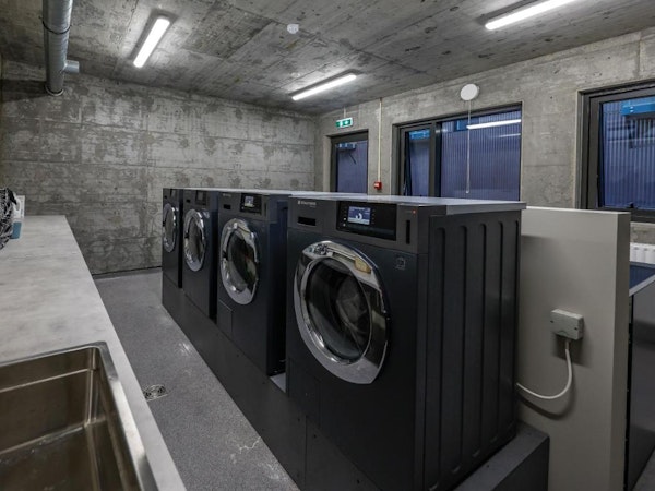 The laundry room with washing machines and dryers at Center Apartments in Reykjavik.