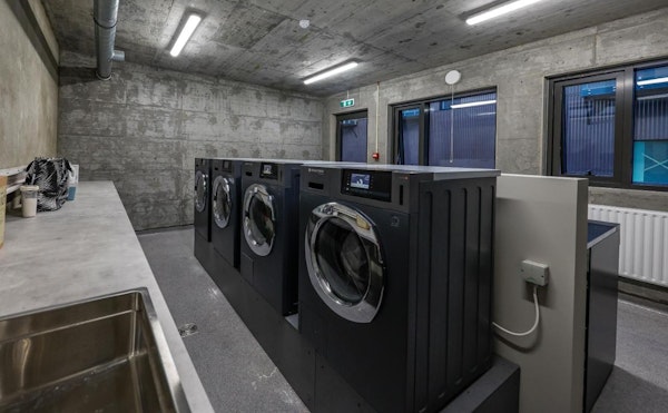 The laundry room with washing machines and dryers at Center Apartments in Reykjavik.