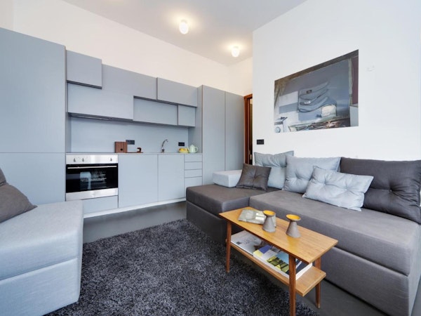 An open-plan living space with a kitchen and sofa at Astro Apartments in central Reykjavik.