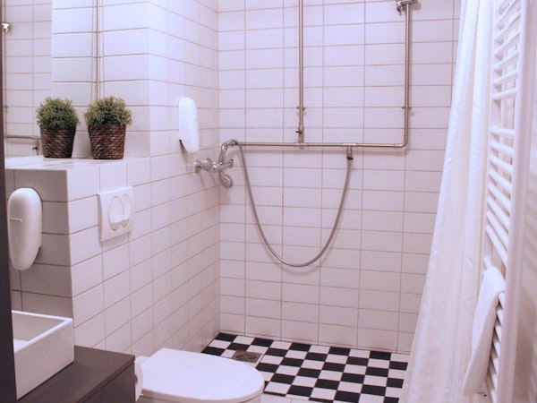 A bathroom with a shower and toilet at Astro Apartments in central Reykjavik.