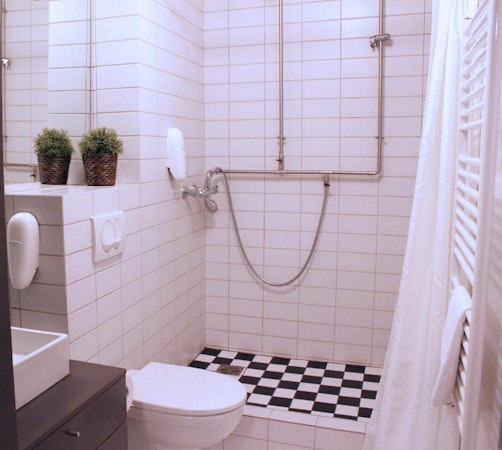A bathroom with a shower and toilet at Astro Apartments in central Reykjavik.