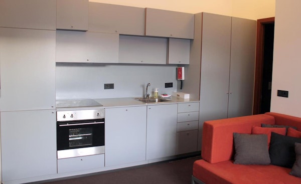 The kitchenette with an oven and stove at Astro Apartments in Reykjavik.