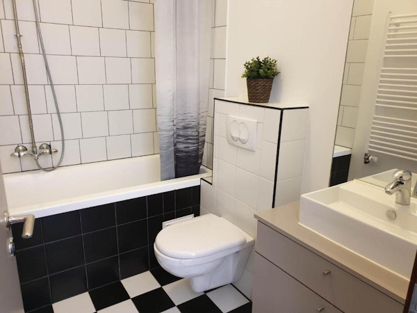 A bathroom with a bath and toilet at Astro Apartments in central Reykjavik.