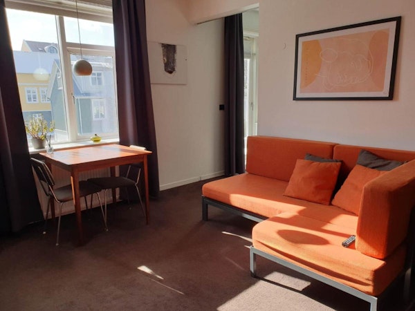 A sofa and small dining table at Astro Apartments in Reykjavik.