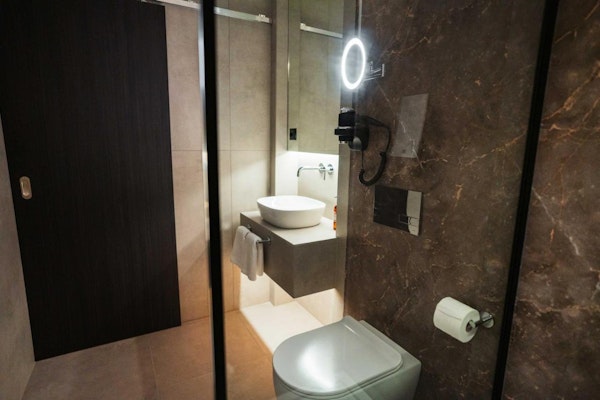 A modern bathroom with a toilet and basin at Konvin Hotel by Keflavik Airport.